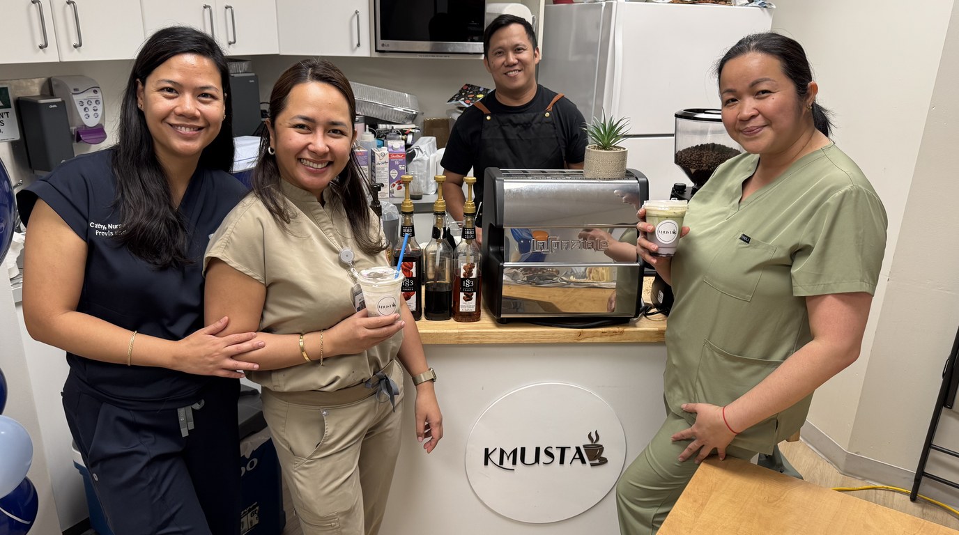 Staff with their drinks at the Kmusta cart set up in their workplace
